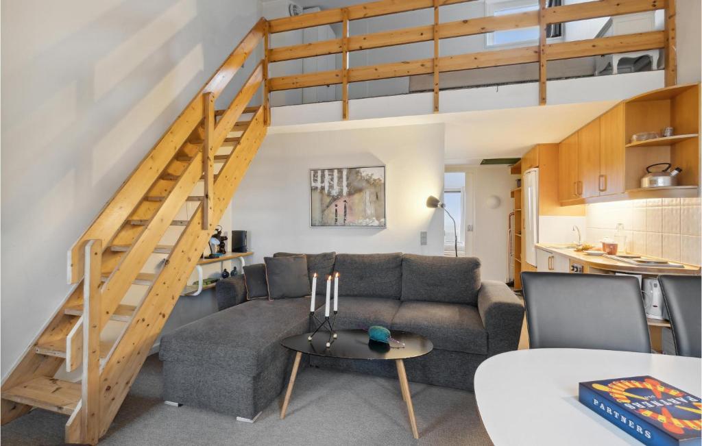 a living room with a couch and a staircase at Fan Bad, Lejl, 71 in Fanø