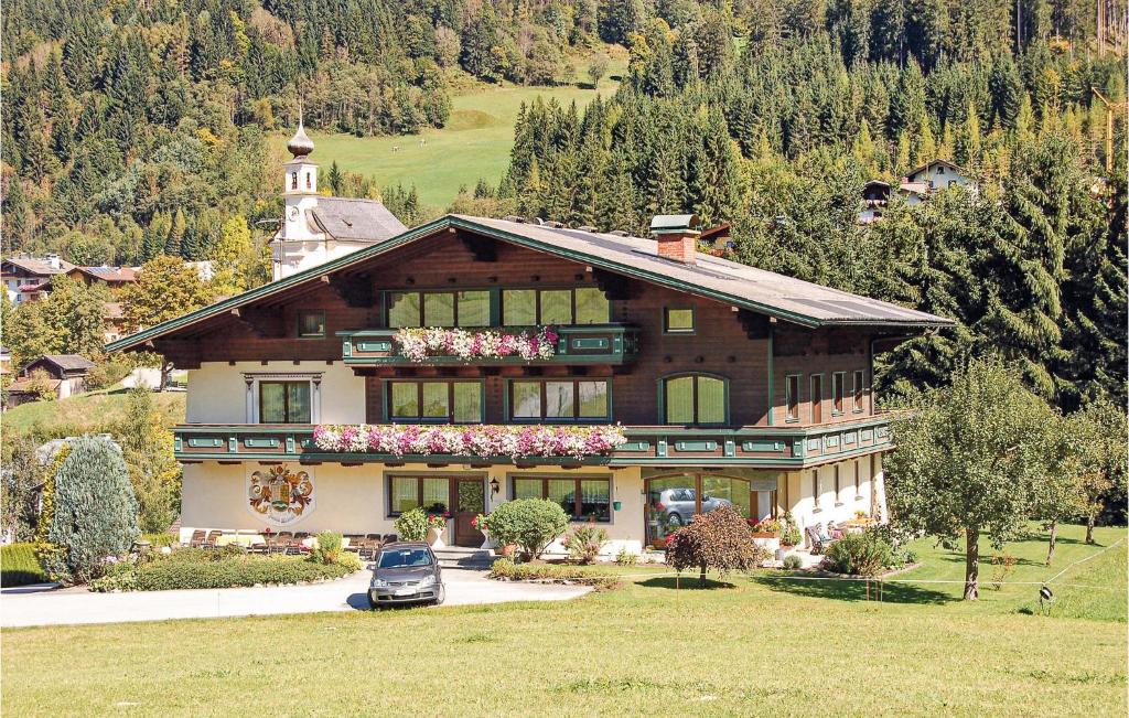 a large house with a car parked in front of it at Awesome Apartment In Flachau With Kitchen in Flachau