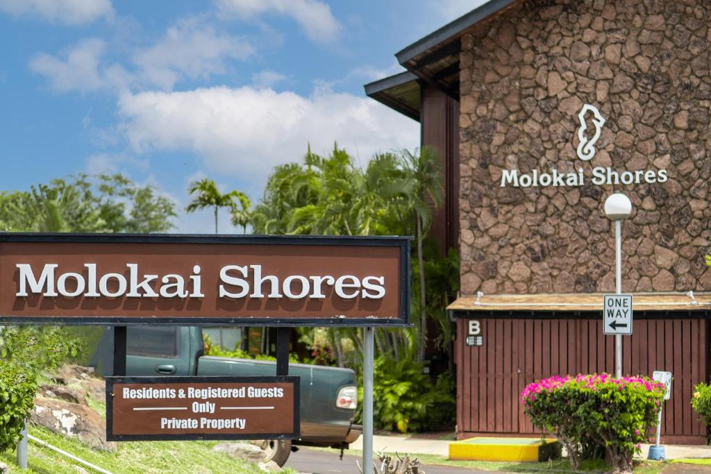 a sign in front of a building with a store at Molokai Shores in Kaunakakai
