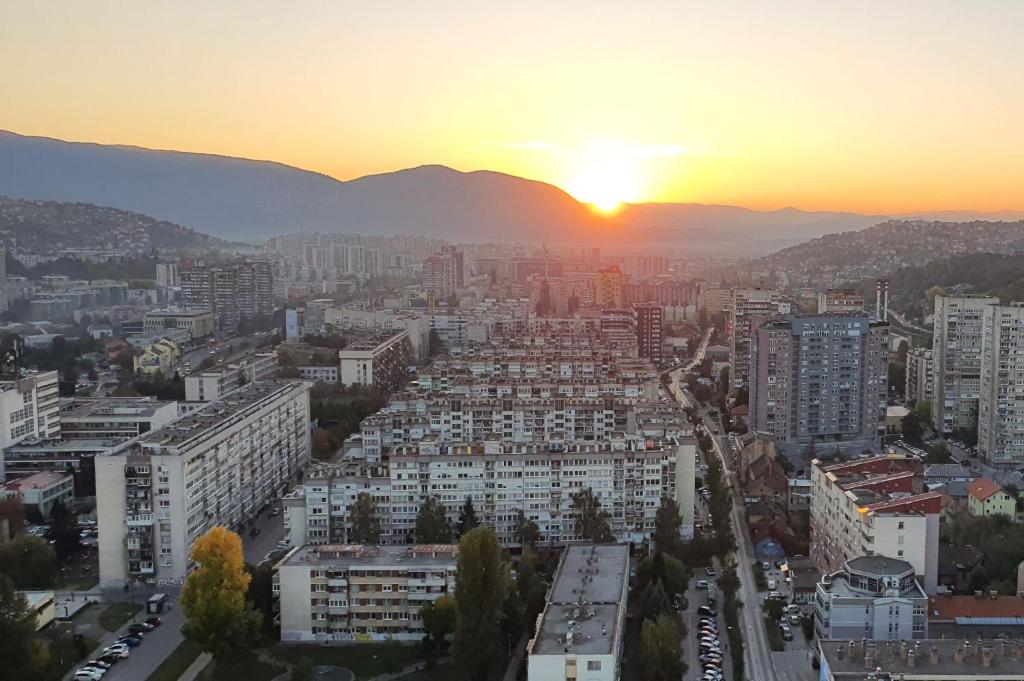 an aerial view of a city at sunset at Sarajevo Tower 24th floor apartment in Sarajevo