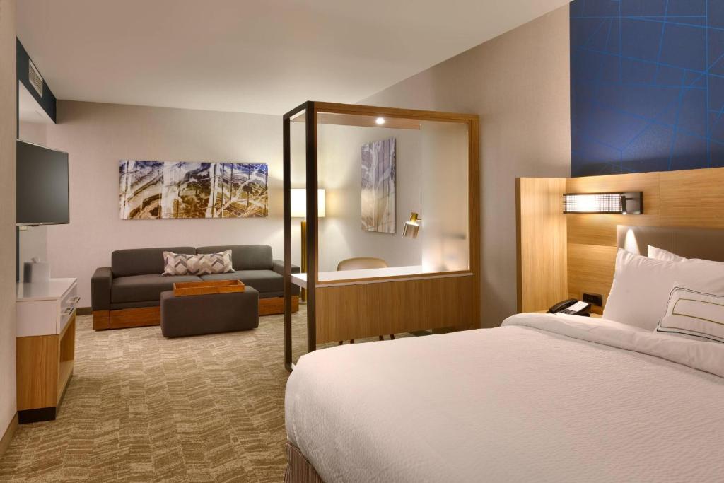 a hotel room with a bed and a couch at SpringHill Suites by Marriott Coralville in Coralville