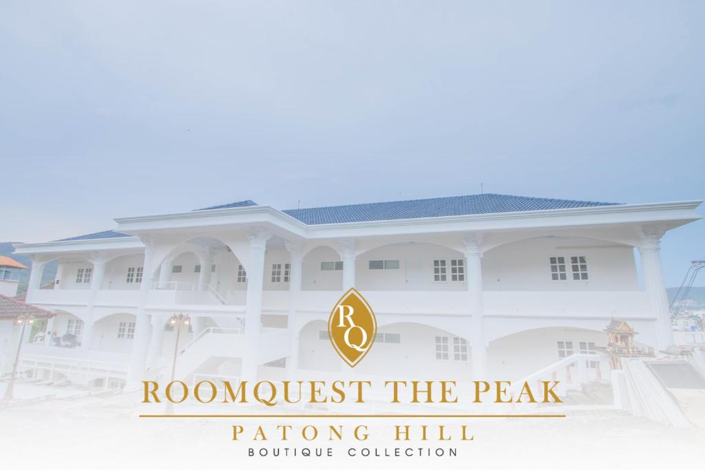 a building with the wordsrooost the peak rating hill boutique collection at RoomQuest The Peak Patong Hill in Patong Beach