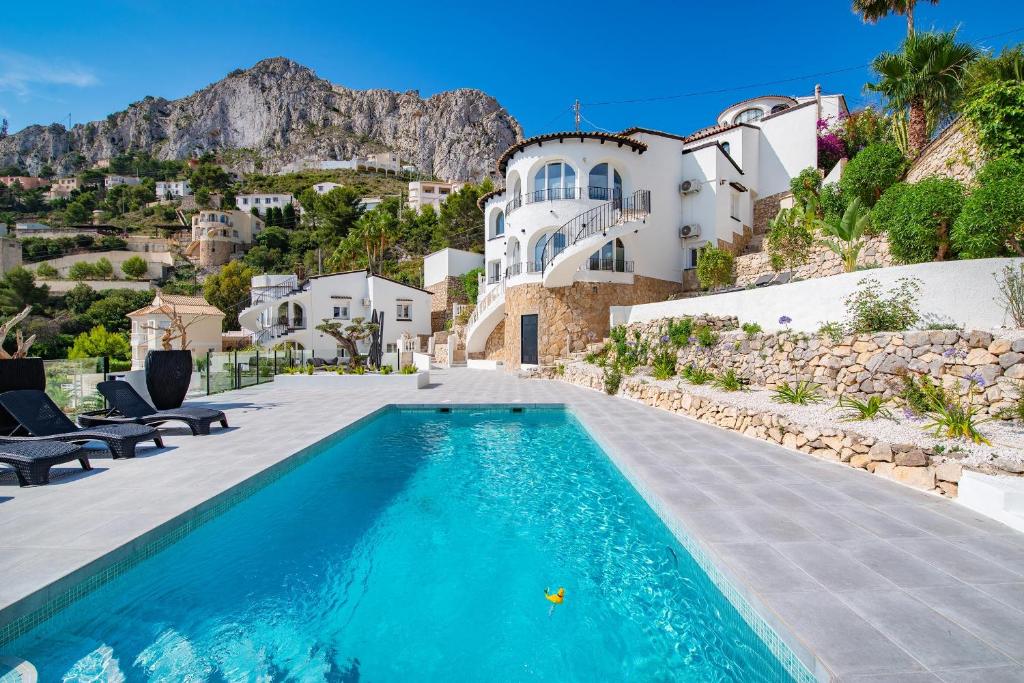 a pool in front of a house with a mountain at Calpeview II Luxury Villa By Calpitality in Calpe