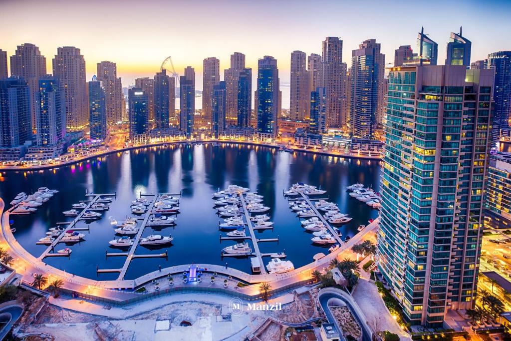 a marina in a city with boats in the water at Manzil - 1BR Home in Dubai Marina with Marina View, Nr JBR Beach & Marina Mall in Dubai
