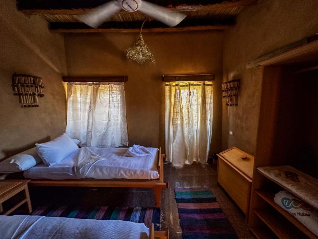 Postel nebo postele na pokoji v ubytování Eco Nubia