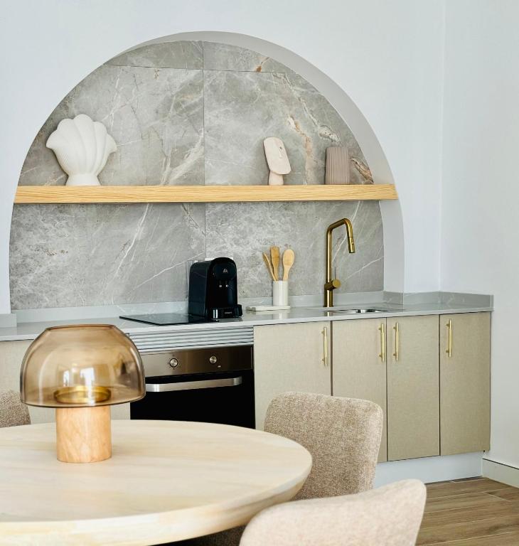 a kitchen with a table and a sink at Canaryislandshost l Beach in Puerto del Carmen