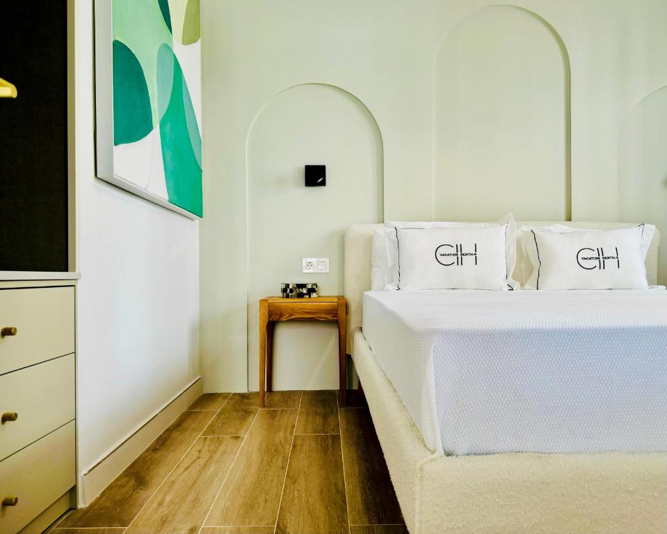 a bedroom with two white beds and a table at Canaryislandshost l Beach in Puerto del Carmen