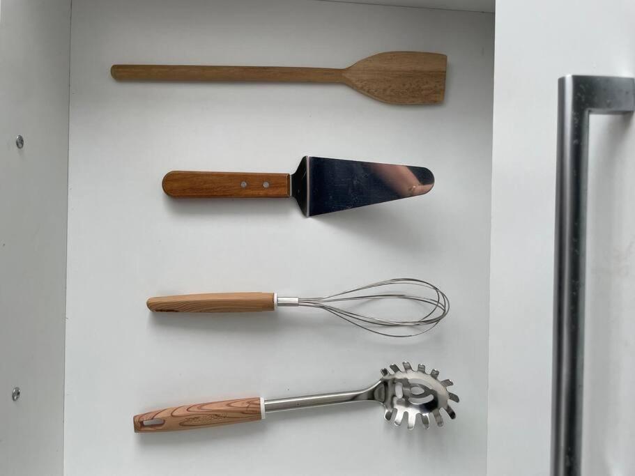 a group of kitchen utensils hanging on a wall at Luxury Experience in Asunción: Fully Equipped in Asunción