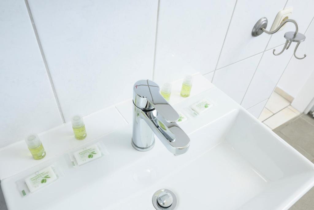 a bathroom with a sink and a faucet at City Center Mödling in Mödling