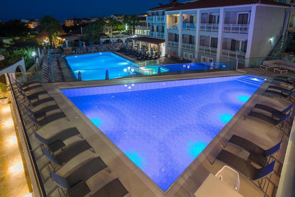an overhead view of a swimming pool at night at Mary Elen Boutique Hotel in Argasi