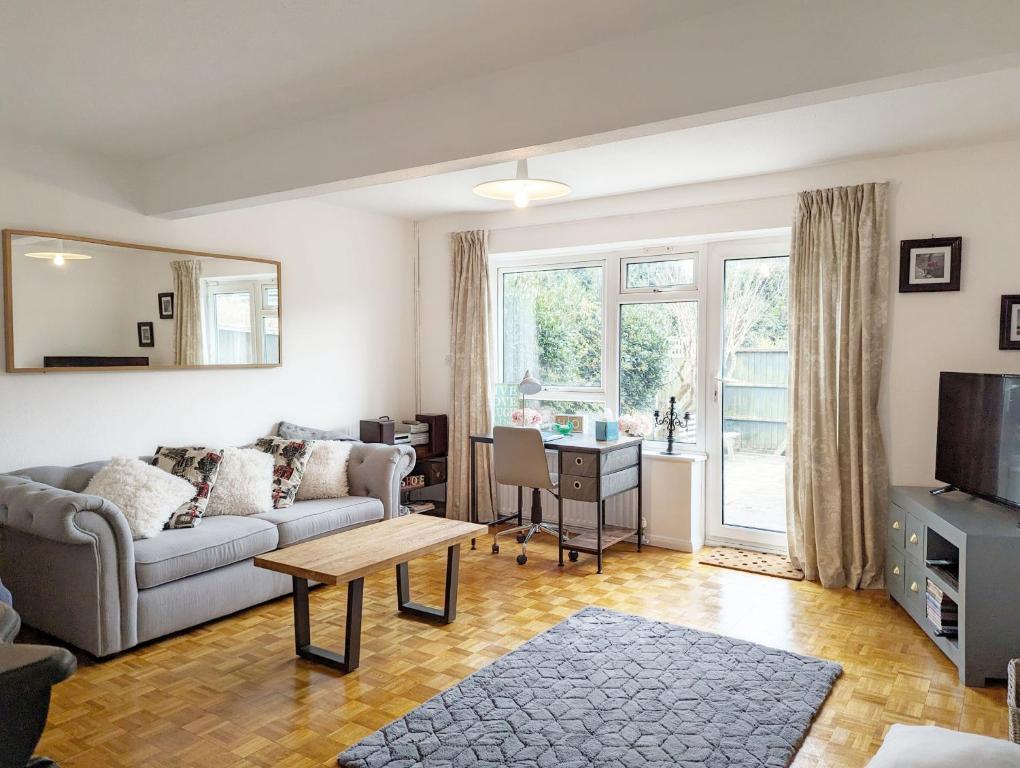 a living room with a couch and a table at Holly House - Rustington in Rustington