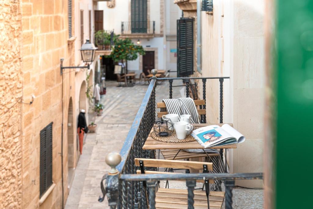 an alley with a table and chairs on a balcony at Sunset Cas Sastre in Alcudia