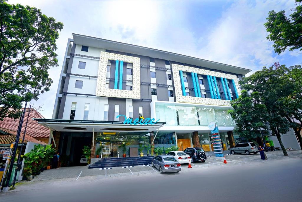 a building with cars parked in front of it at Meize City Center Bandung in Bandung