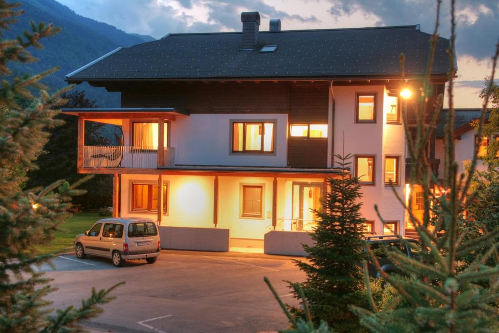 ein Haus mit einem Auto auf einem Parkplatz in der Unterkunft Aktiv & Sport Apartments Oberjörg in Rattendorf