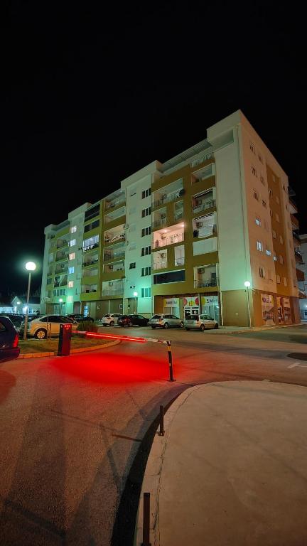 a large building at night with a red light at Apartman SUNCE in Trebinje