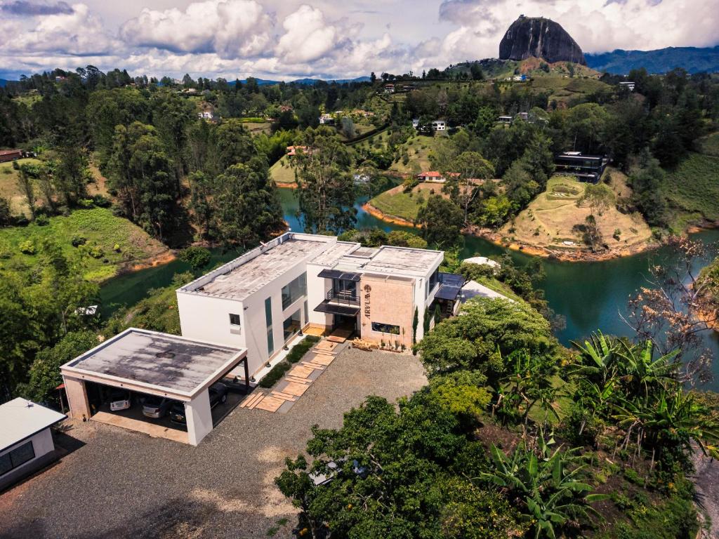 an aerial view of a house next to a river at Arvum Hotel Boutique in Guatapé