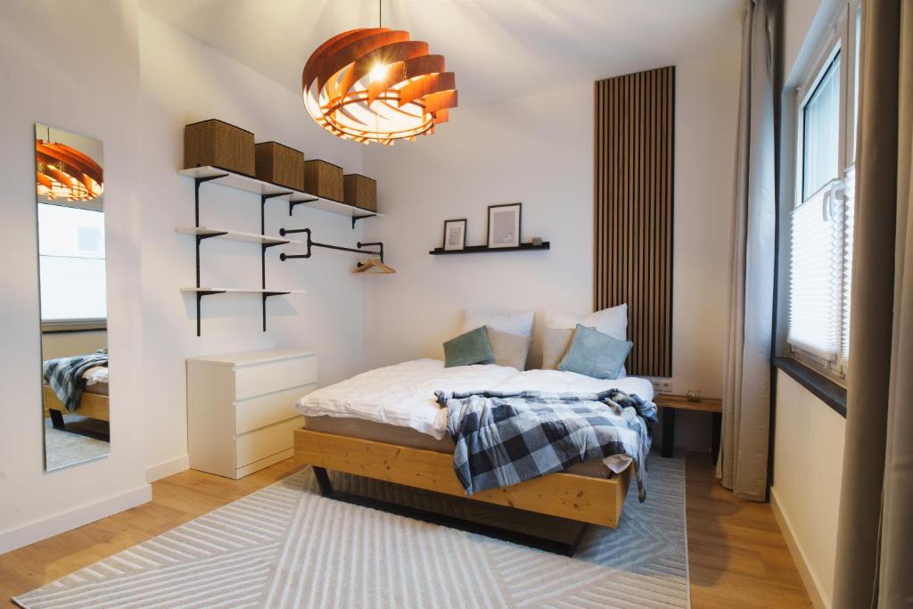 a bedroom with a bed and shelves and a window at Apartment Innenstadt- Zentral und Exklusiv in Bestlage, Stilvolles Ambiente, alles zu Fuß erkunden in Braunschweig