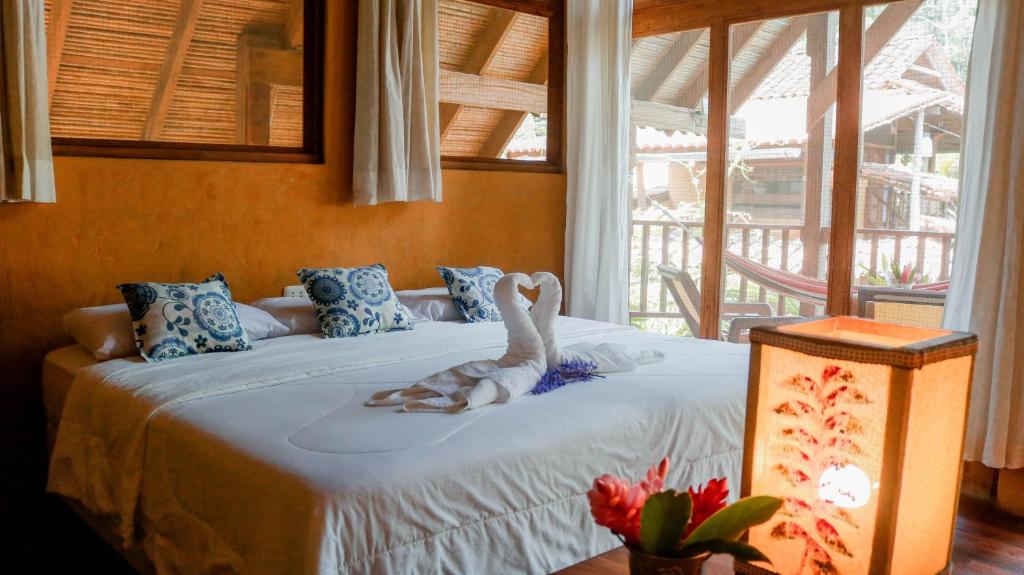 a bedroom with a bed with a swan on it at Canto del Río Lodge in Tarapoto