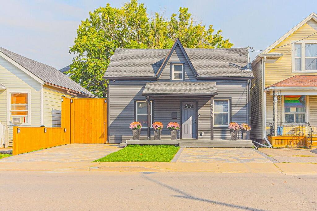 a gray house with a fence in front of it at Niagara Property in Niagara Falls