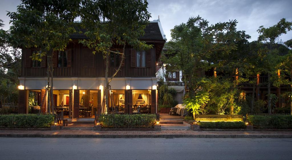 a building with benches in front of a building at Burasari Heritage Luang Prabang in Luang Prabang