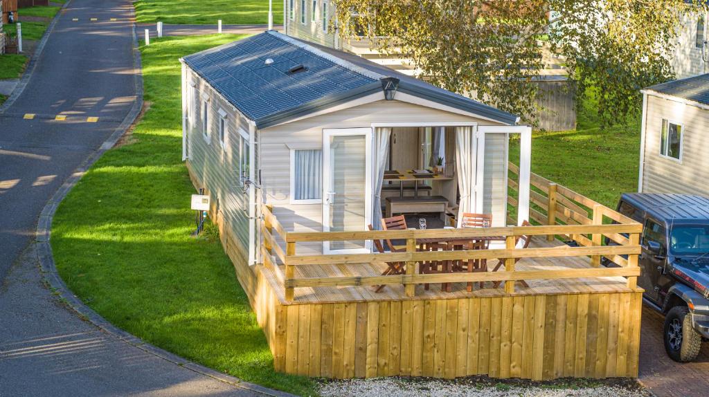 a tiny house sitting on the side of a road at Luxury Chalet Near Dornoch, high speed free Wi-Fi in Dornoch