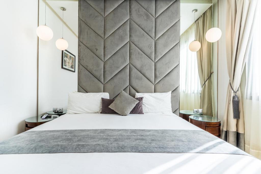 a bedroom with a large bed and a wall at One Hotel Casablanca in Casablanca
