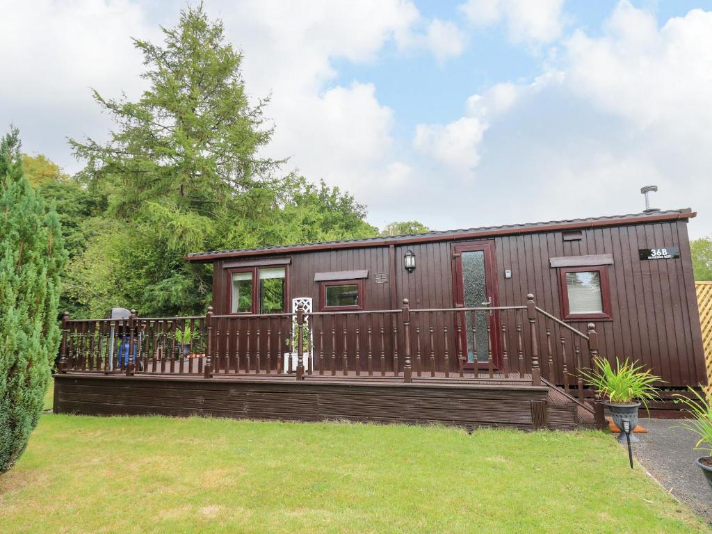 a tiny house with a large deck at Riverside Rest in Builth Wells