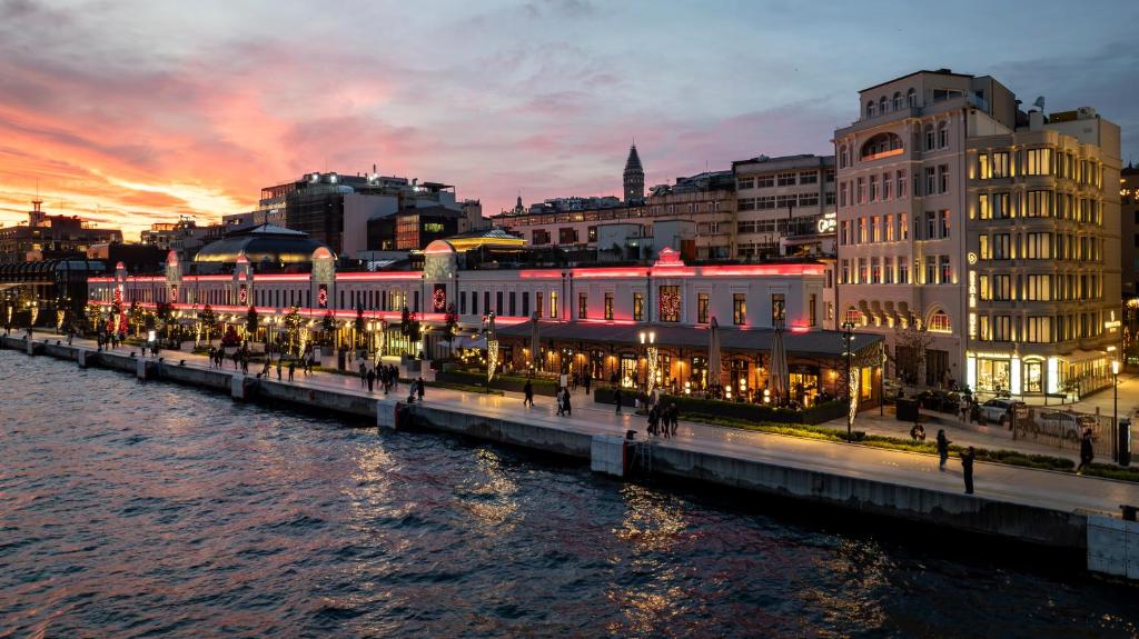 a city with a river and buildings at night at Dream Inn Karaköy Bosphorus in Istanbul