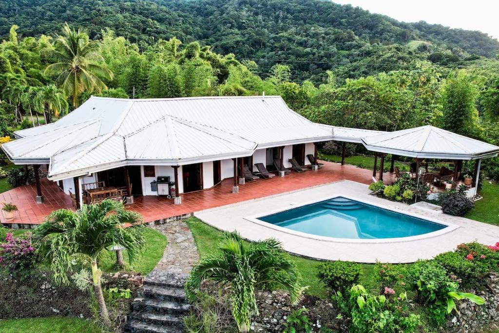 an aerial view of a house with a swimming pool at Parrot Estate Villa in Englishmanʼs Bay