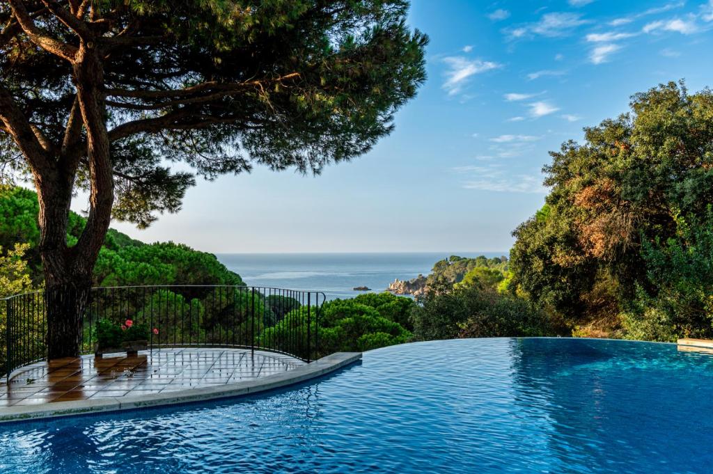 a swimming pool with a view of the ocean at Albamar Apartaments in Lloret de Mar