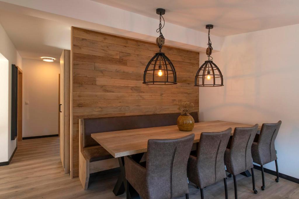 a dining room with a wooden table and chairs at Drei Türme Top A5 in Schruns