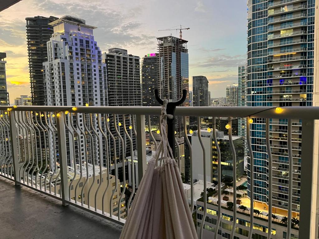 an umbrella on a balcony with a city skyline at City & Sea View+FREE Parking Modern Condo in Miami