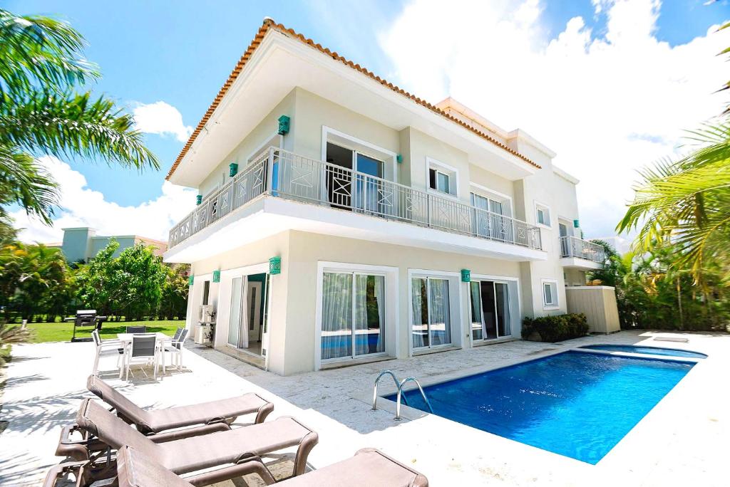 a villa with a swimming pool and a house at Luxury Villa Iberosta - 4BDR, Private Beach, Pool & Jacuzzi in Punta Cana