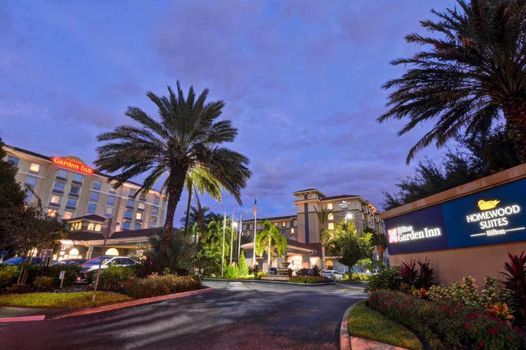 a street in front of a hotel with palm trees at Homewood Suites by Hilton Lake Buena Vista - Orlando in Orlando