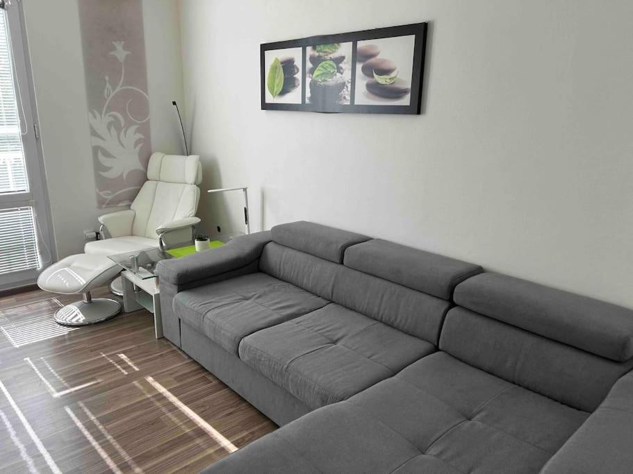a living room with a couch and a chair at ApartmánTonki v centre mesta Piešťany in Piešťany
