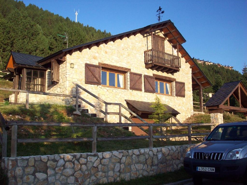 a house with a car parked in front of it at Port del Comte a pie de pistas in La Coma i la Pedra