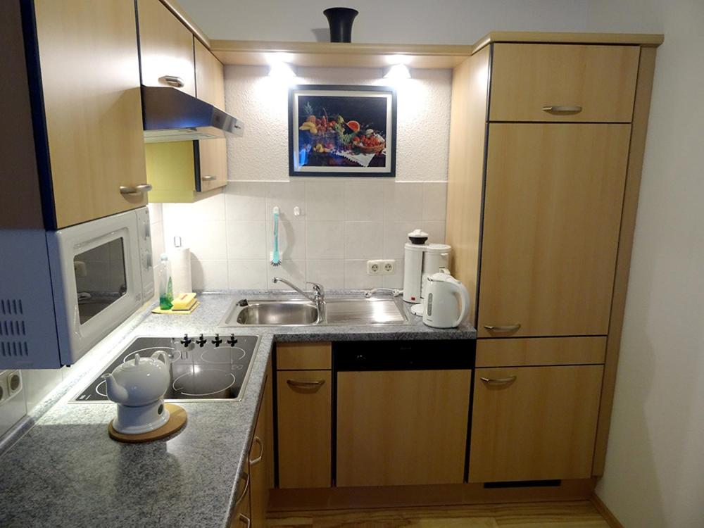 a small kitchen with a sink and a microwave at Clemens 1 in Wangerooge