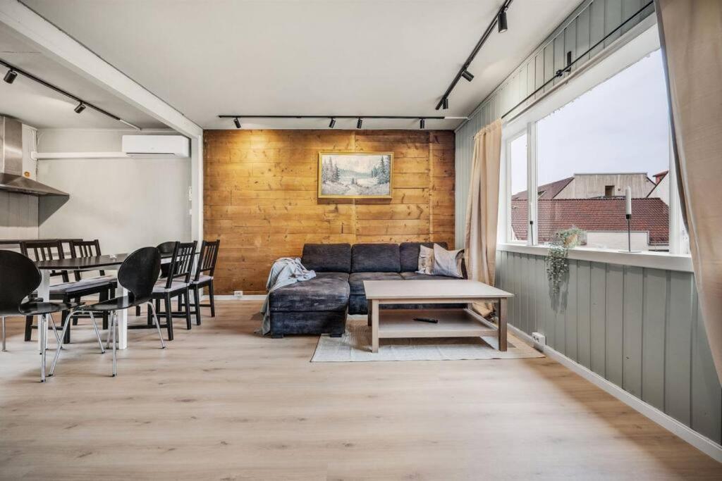 a living room with a couch and a table at Dinbnb Apartments I Romantic Surrourings in Bergen