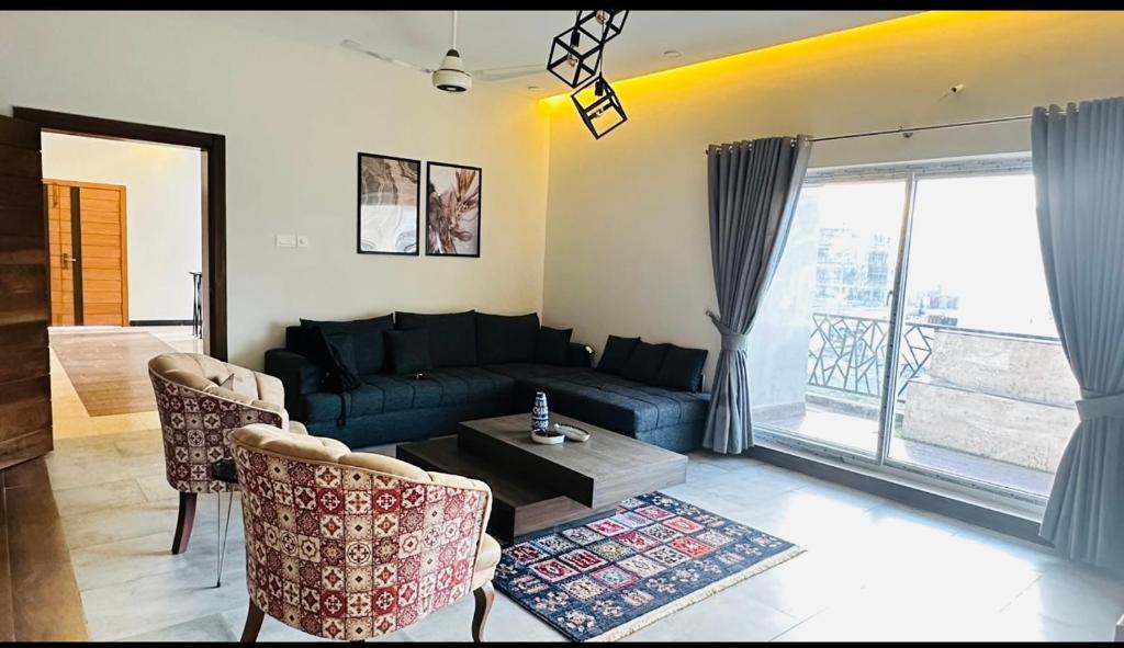 a living room with a couch and a table at Private entire 3 bedroom portion in Islamabad in Islamabad