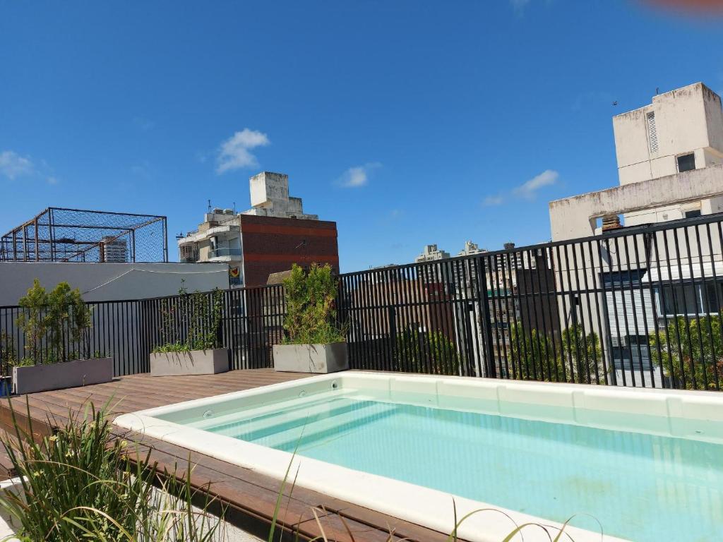 a swimming pool on a patio with a fence at GRATA NERA in Rosario