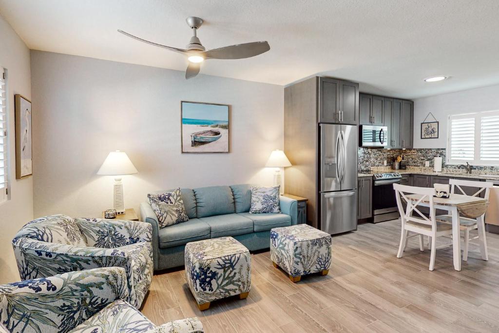 a living room with a couch and a kitchen at Ocean Isles #28 in Marathon