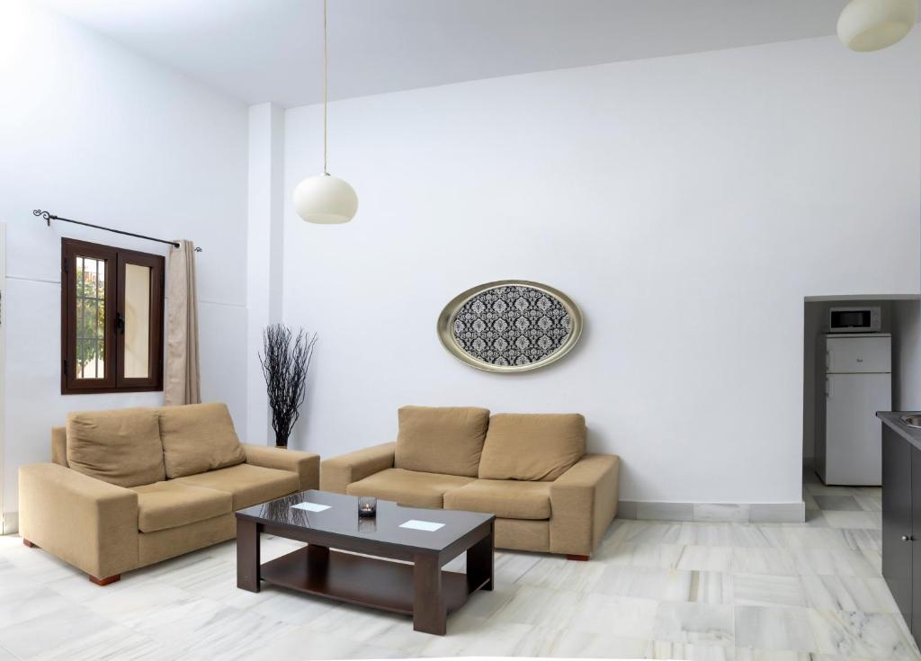 a living room with two couches and a coffee table at Palacio de Luja in El Puerto de Santa María