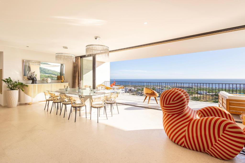 El Pueblito的住宿－Ocean view Luxury Retreat，客厅配有桌椅,享有海景。
