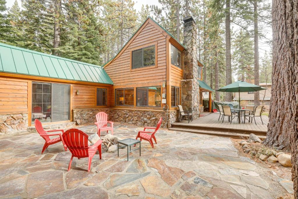 a house with red chairs and a stone patio at Less Than 1 Mi to Lake Tahoe Beaches Home with Fire Pit! in Tahoe City