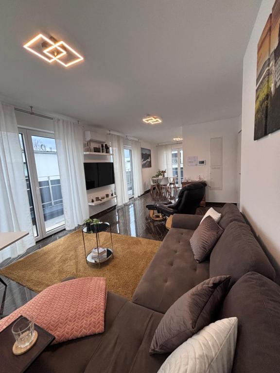 a living room with a large brown couch in a living room at Ferienwohnung-Weinstadt in Weinstadt