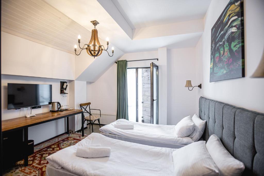 Postel nebo postele na pokoji v ubytování Hotel Roshe Gudauri
