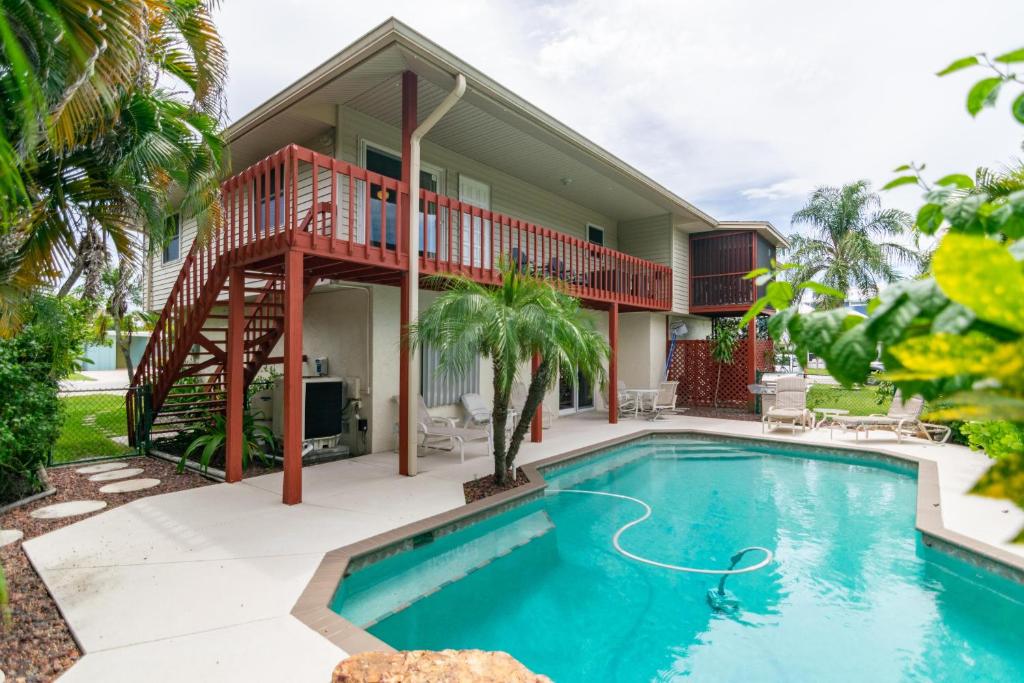 una casa con piscina e terrazza di A Wright Place a Holmes Beach