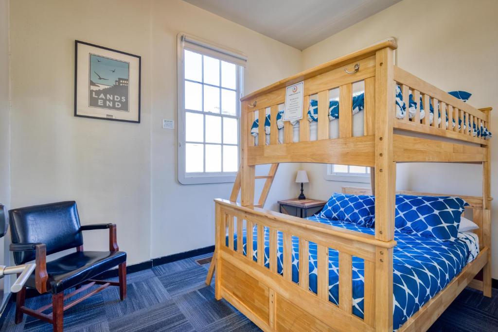 a bedroom with a bunk bed and a chair at HI San Francisco Fisherman's Wharf Hostel in San Francisco