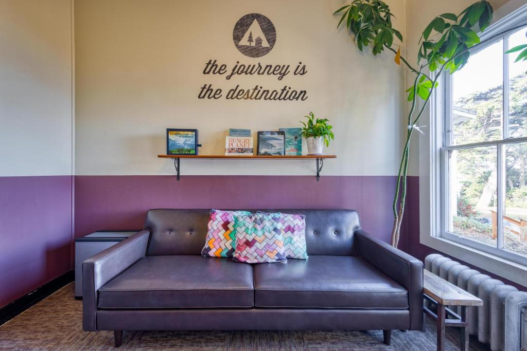a couch in a living room with a purple wall at HI San Francisco Fisherman's Wharf Hostel in San Francisco
