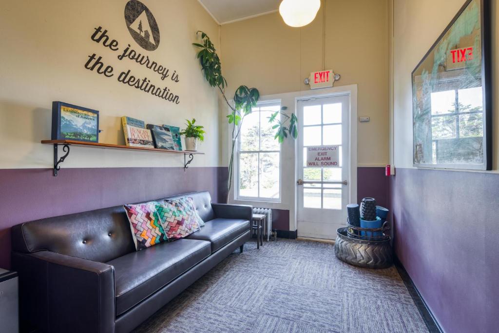 a waiting room with a leather couch and a door at HI San Francisco Fisherman's Wharf Hostel in San Francisco